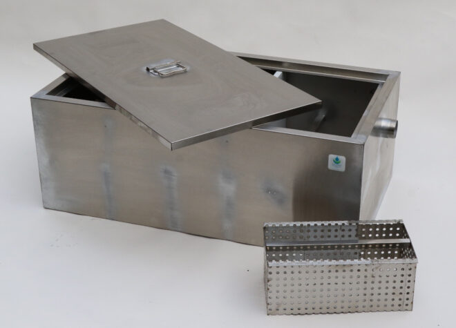 Grease trap with lid slightly off and food basket